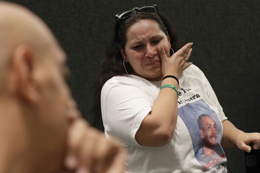 LOS ANGELES CA APRIL 10, 2018 -- Valerie Rivera, the mother of 20-year-old Eric Rivera who was shot and killed by LAPD officers last summer, sobs after addressing Los Angeles Police Commission. Phillip Malik father of the victim is seen on left. Eric Rivera died last summer after he was shot by officers, then run over by their uncontrolled patrol car. (Irfan Khan / Los Angeles Times)