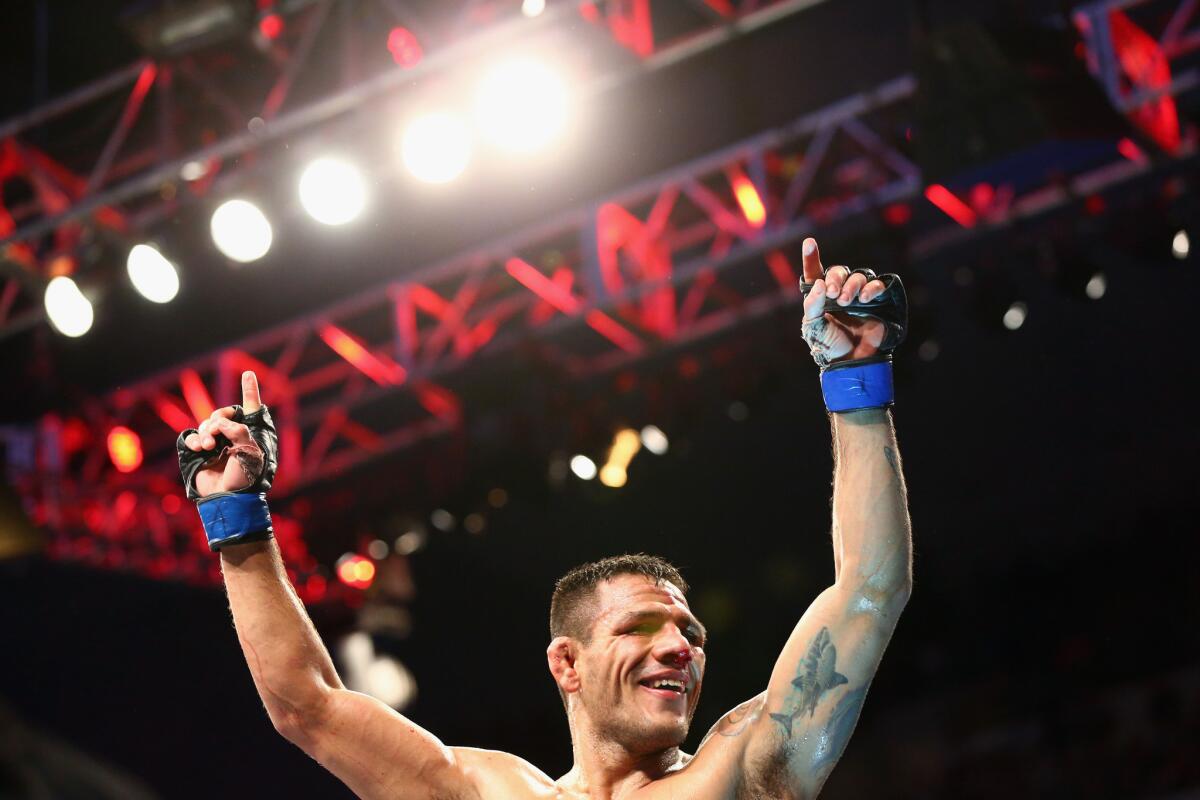 Rafael Dos Anjos celebrates after beating Anthony Pettis by unanimous decision for the UFC lightweight title Saturday at American Airlines Center in Dallas.