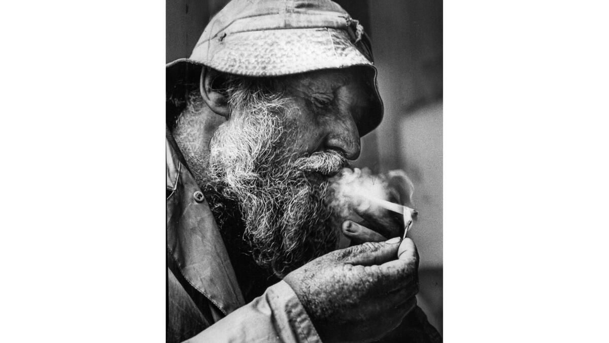 Feb. 11, 1968: Homeless man Clint Wescott lights a cigarette after refusing nearly $20,000. This photo appeared in the Feb. 12, 1968, edition of The Times.