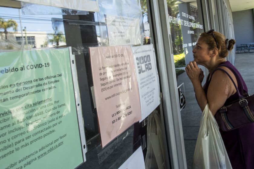 CANOGA PARK, CA - MAY 14: Brenda Bermudez came looking for information about her unemployment claim but found the California State Employment Development Department closed on Thursday, May 14, 2020 in Canoga Park, CA. (Brian van der Brug / Los Angeles Times)