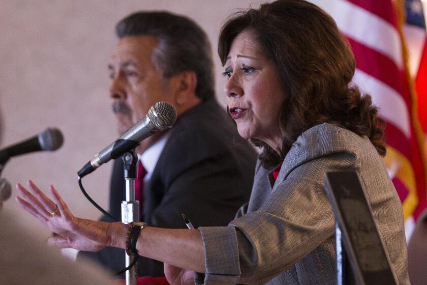 Supervisor candidates Hilda Solis, right, and Juventino "J" Gomez answer questions during a lunch forum in Pomona.