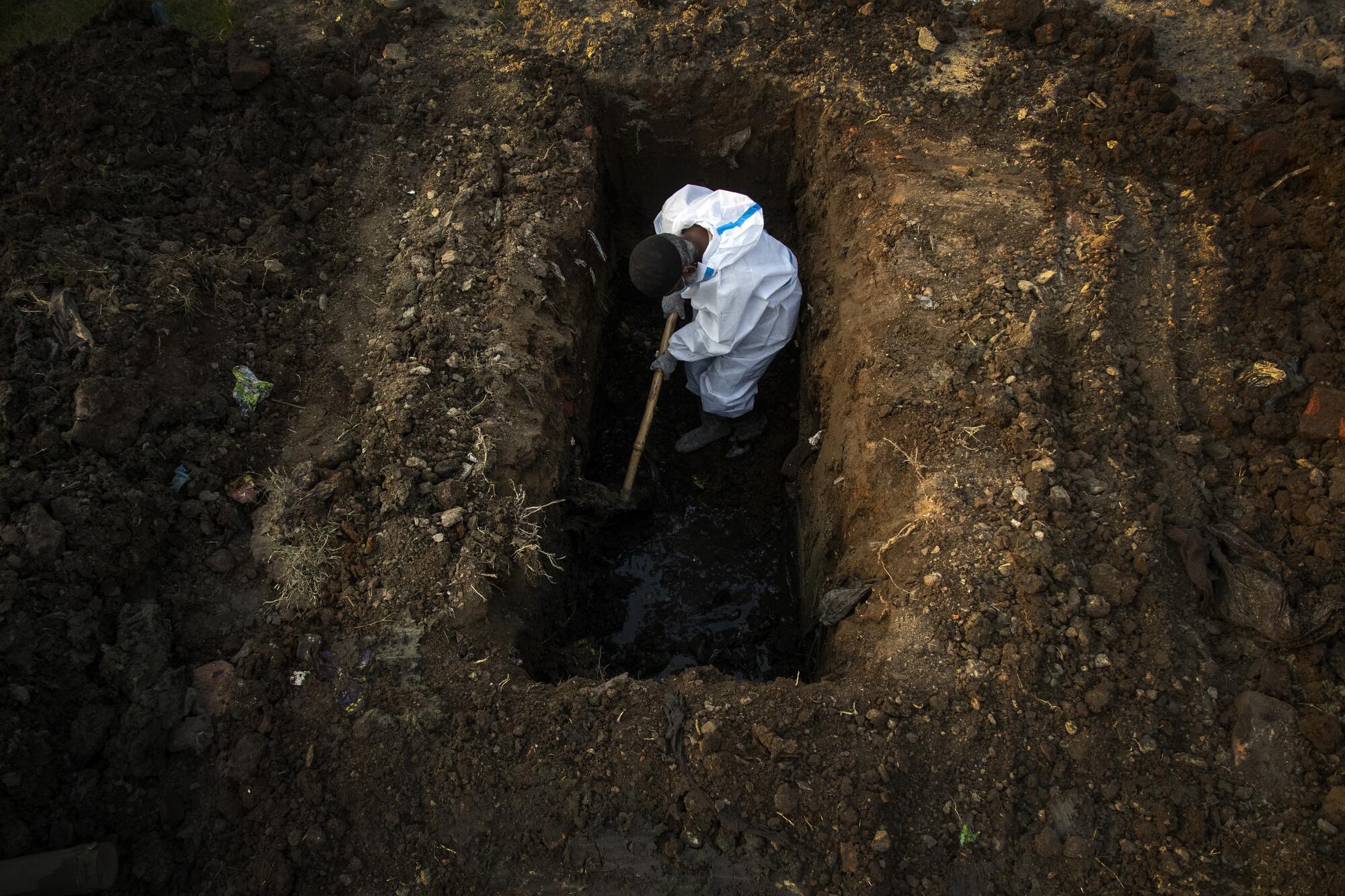 A  man digs a grave. 