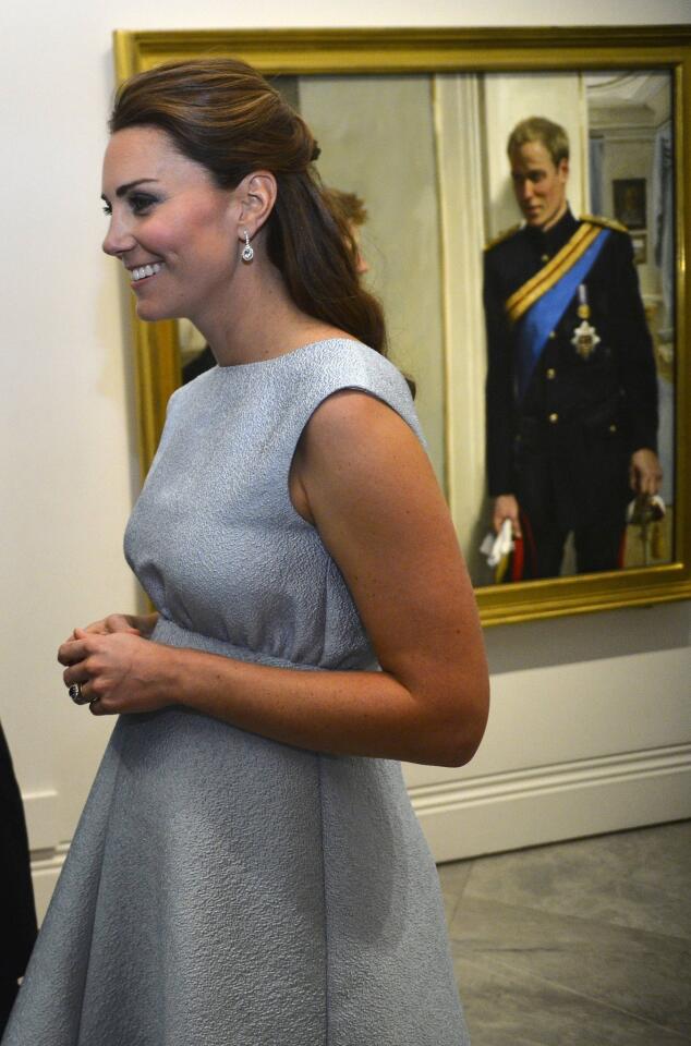 The duchess walks past a painting of Prince William at the National Portrait Gallery in London. The Art Room, for which she is a patron, is a charity offering art as therapy to increase children's self-confidence and independence.