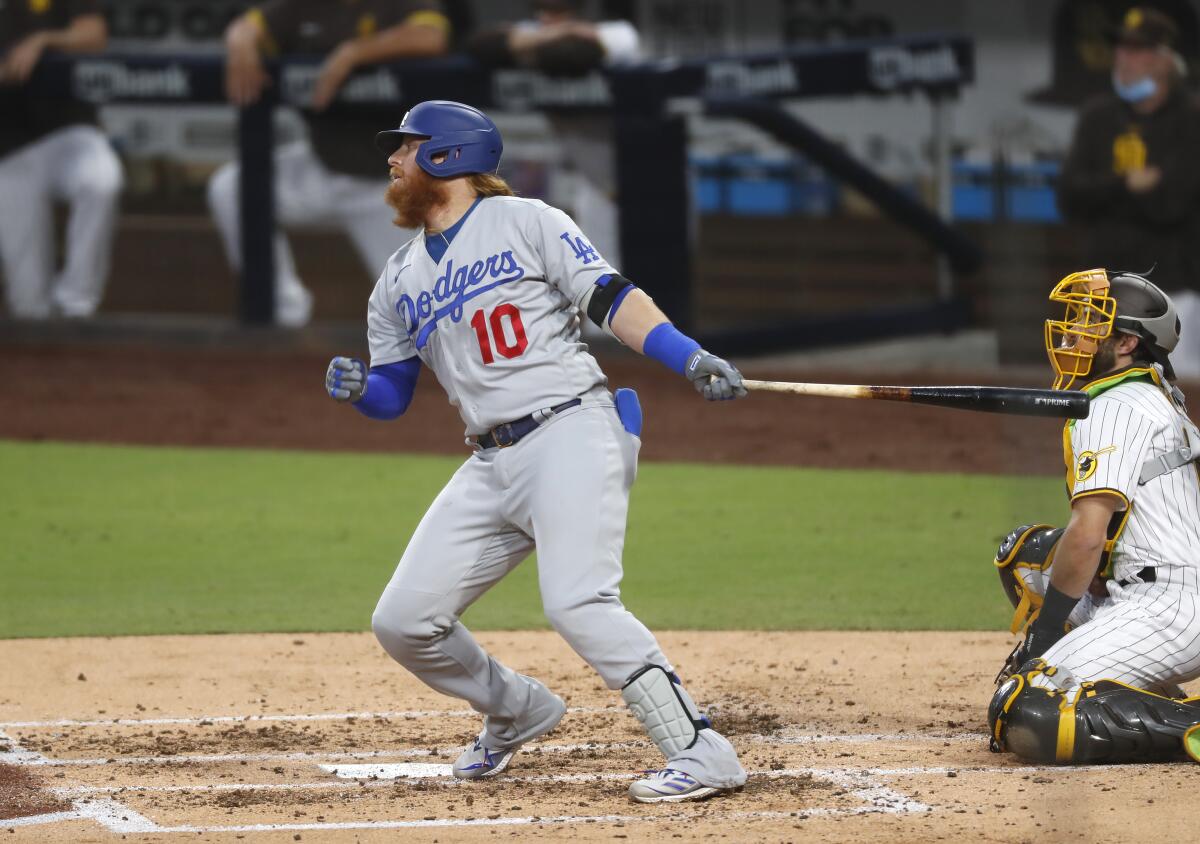 Dodgers' Justin Turner hits a single against the San Diego Padres.