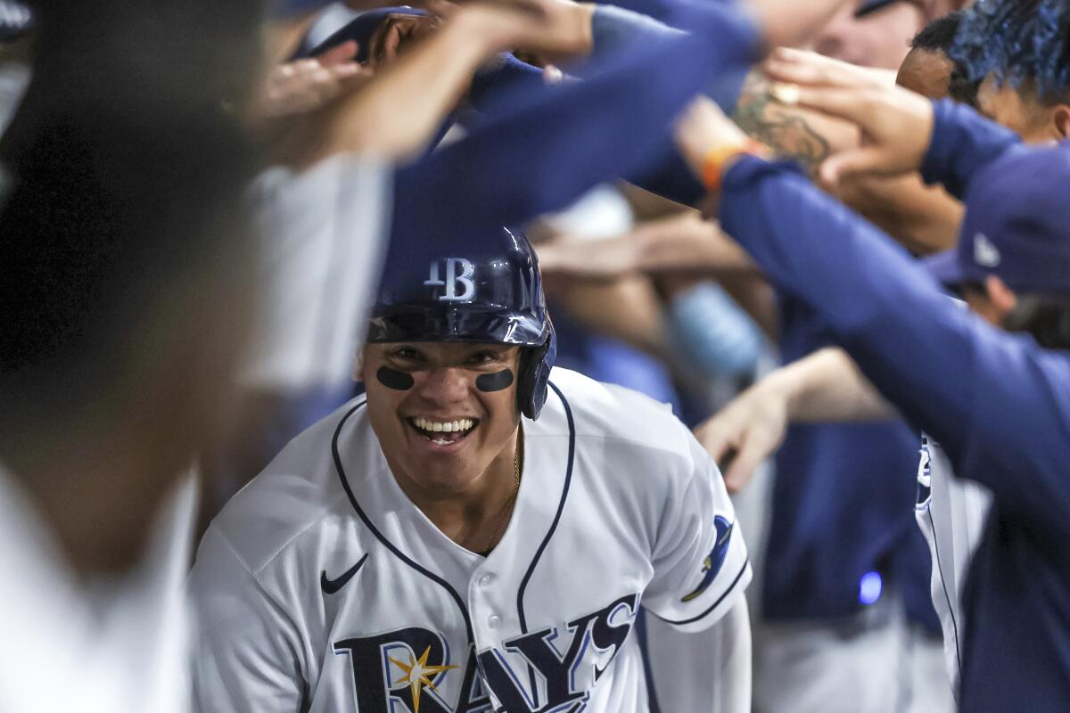 Tampa Bay Rays' Yu Chang celebrates in the dugout after hitting a home run against the Boston Red Sox during the sixth inning of a baseball game Tuesday, Sept. 6, 2022, in St. Petersburg, Fla. (AP Photo/Mike Carlson)