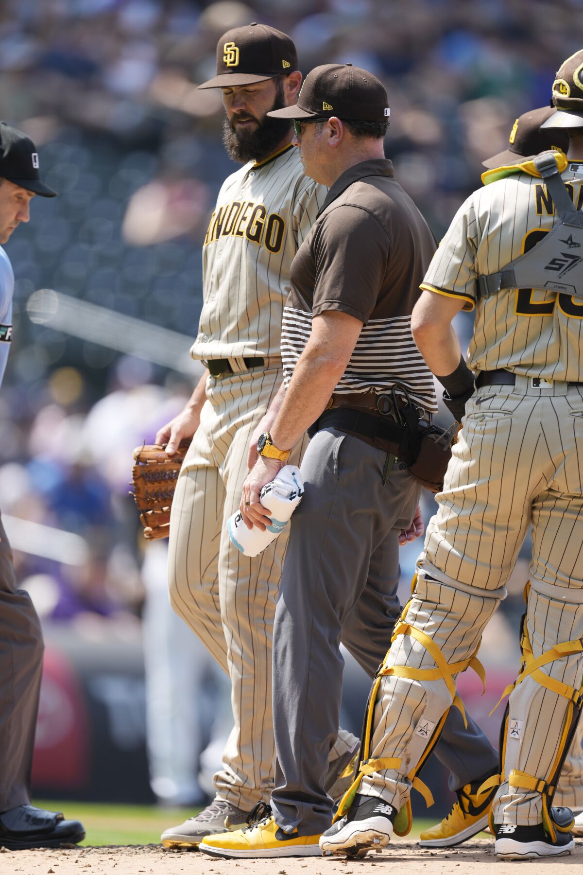 Jake Arrietta confers with Padres head athletic trainer Mark Rogow 