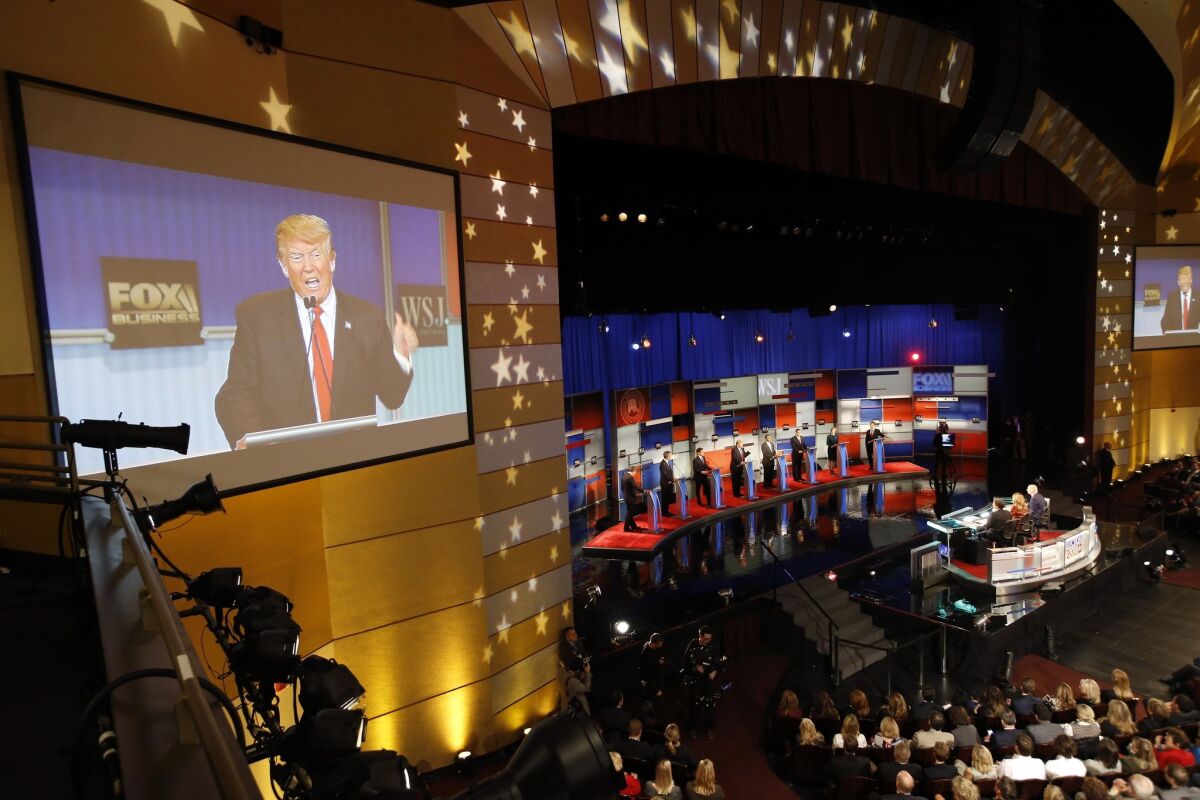 Donald Trump is seen on the screen as Republican presidential candidates John Kasich, Jeb Bush, Marco Rubio, Trump, Ben Carson, Ted Cruz, Carly Fiorina and Rand Paul appear during Republican presidential debate at the Milwaukee Theatre.