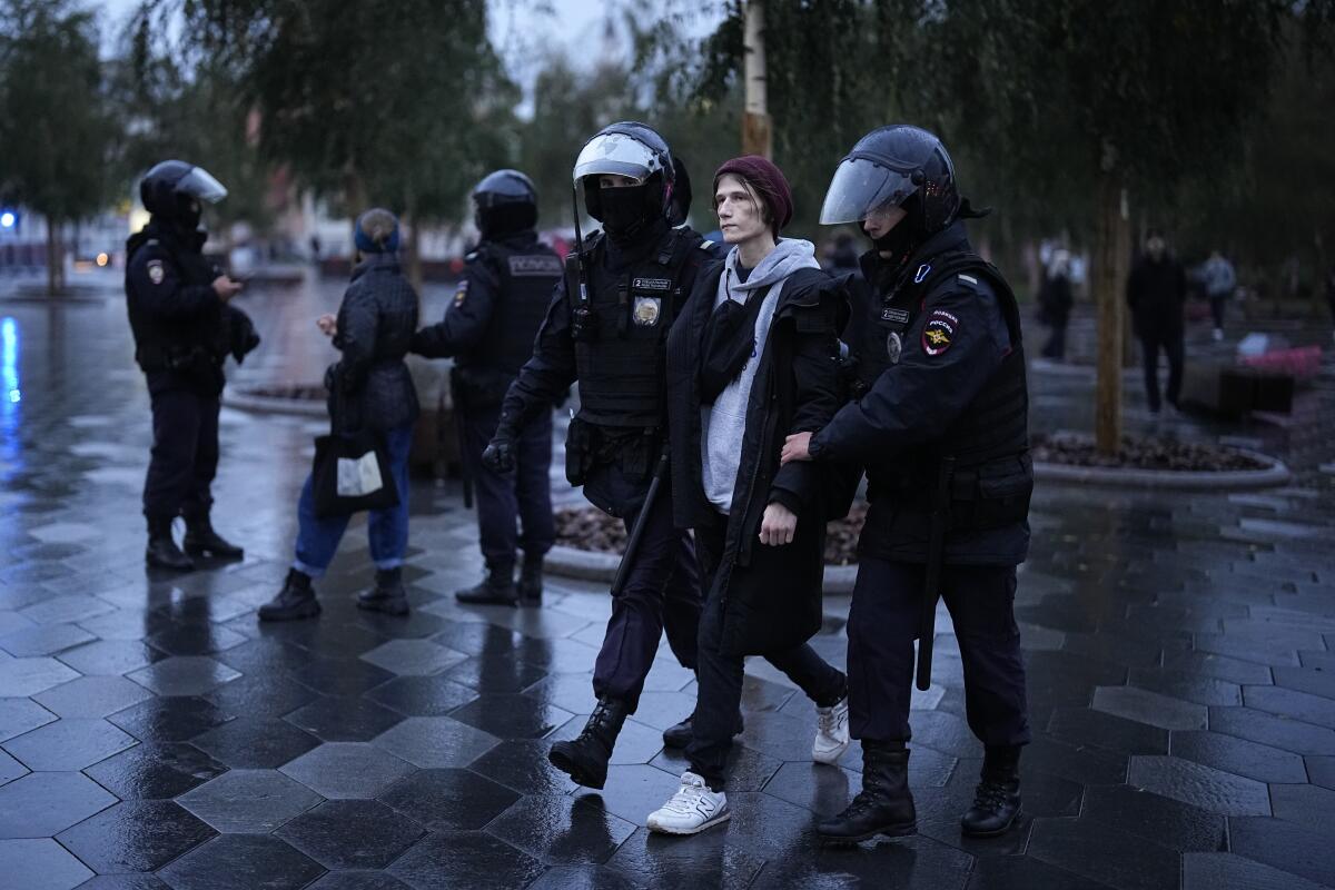 Police officers detain a demonstrator during a protest against a partial mobilization in Moscow.