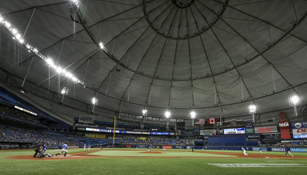 Tampa Bay Rays' Austin Meadows, left, hits a bases-loaded two-run single off Toronto Blue Jays starter Alek Manoah, center, during the third inning of a baseball game Friday, July 9, 2021, in St. Petersburg, Fla.(AP Photo/Steve Nesius)