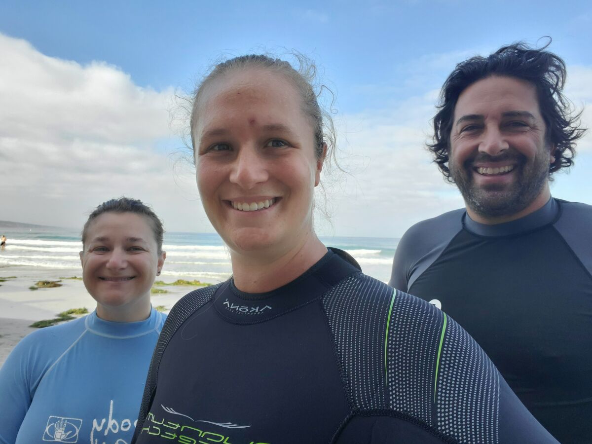 Maya Rich, Ashley Mackin-Solomon and Dovi Kacev prepare to venture into the ocean at La Jolla Shores.