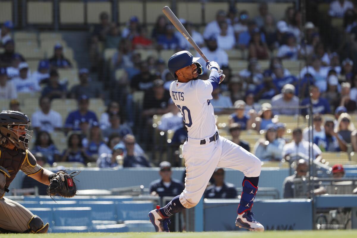 Dodgers right fielder Mookie Betts hits a ninth inning double against the San Diego Padres Sunday at Dodger Stadium. 