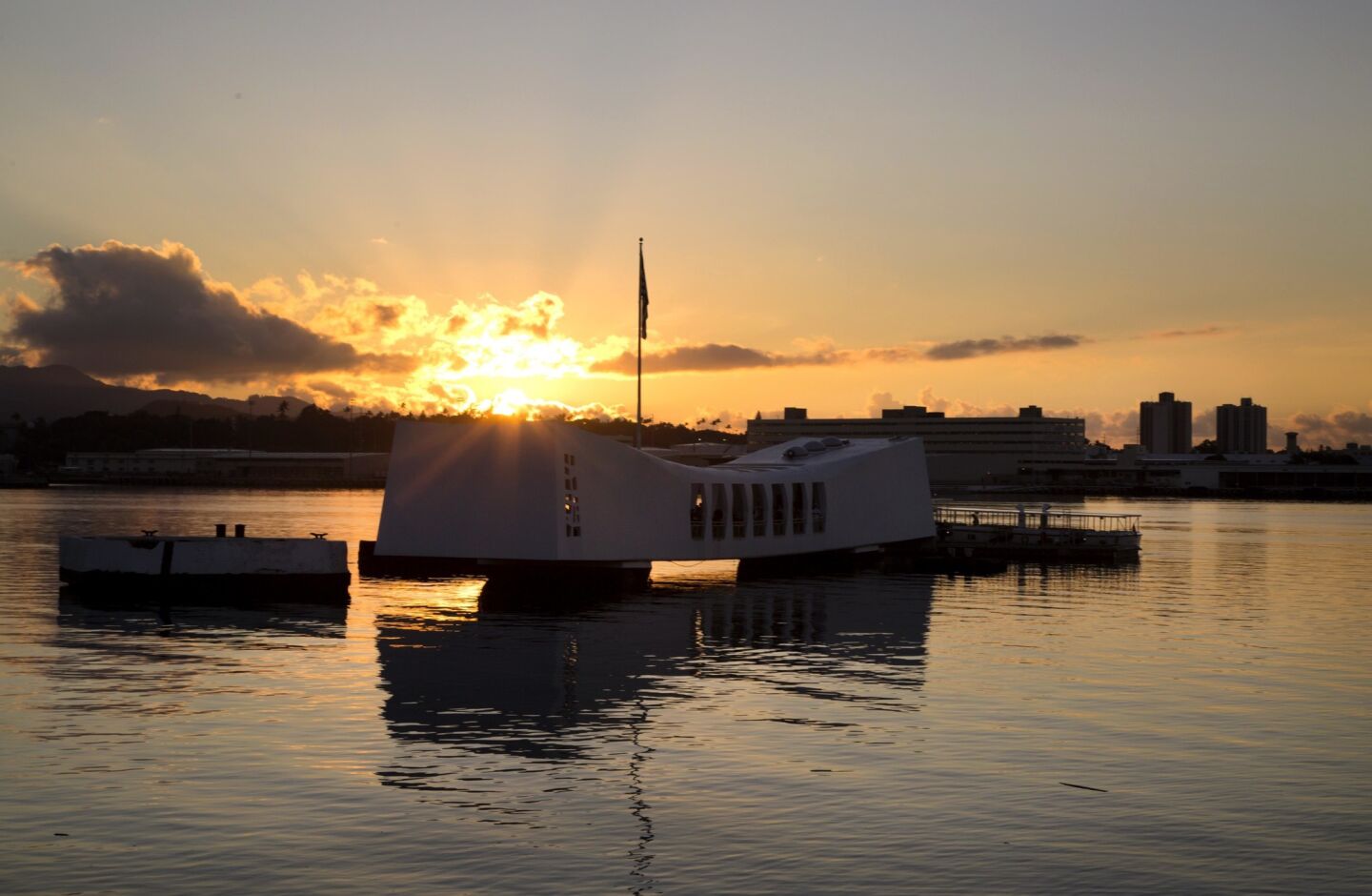 The sun rises behind the battleship USS Arizona Memorial at Pearl Harbor, Hawaii, as commemorations continue leading up to Wednesday, and the 75th anniversary of the Japanese attack on Pearl Harbor, December 7, 1941, thrusting The United States into World War II.