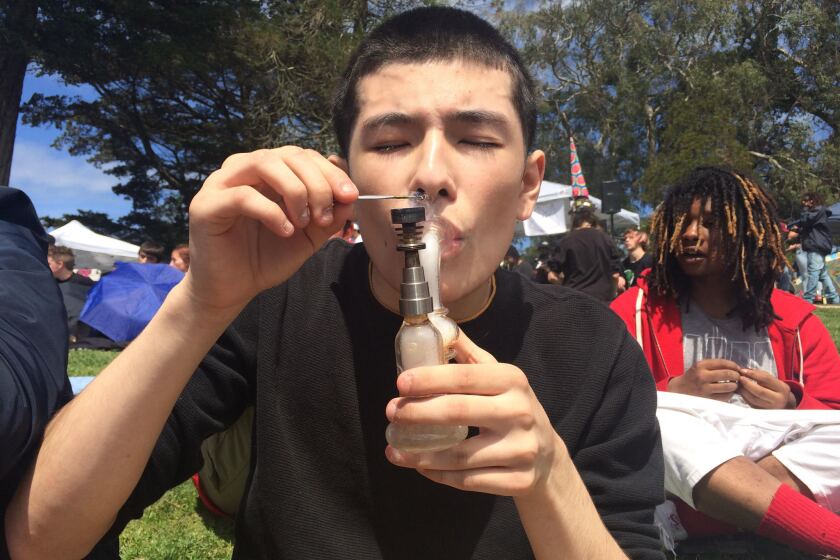Sebastian Rosales smokes in Golden Gate Park in San Francisco on April 20, for the annual 4/20 celebration, in what could be the final year that the recreational use of marijuana is illegal in California.