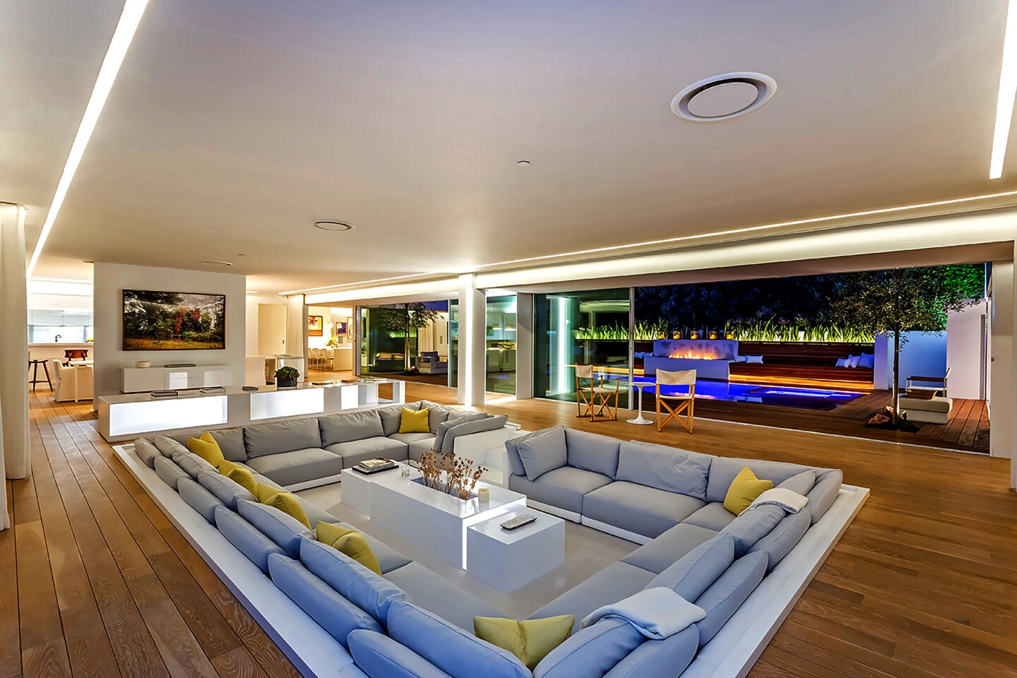 The single-story house, built in 1960, evokes a Miami night club with an all-white interior, a sunken conversation pit and custom LED lighting.