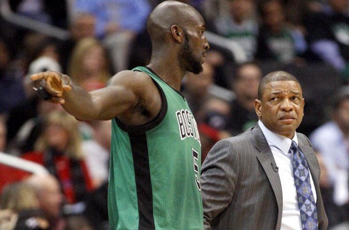 Celtics power forward Kevin Garnett talks with Coach Doc Rivers during a game against the Clippers last season at Staples Center.