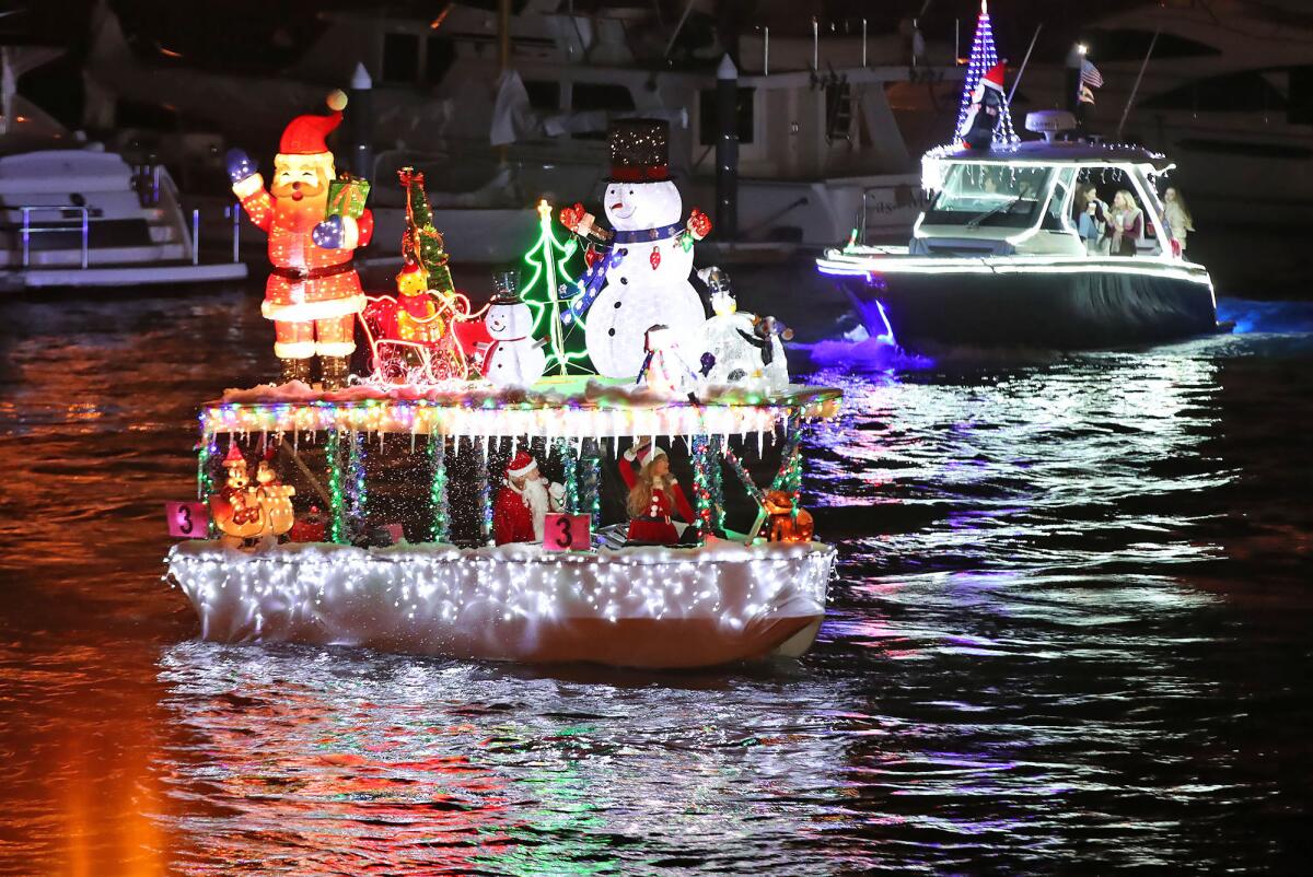 A Duffy boat near the Balboa Island Bridge on opening night of the 115th Annual Newport Beach Christmas Boat Parade.