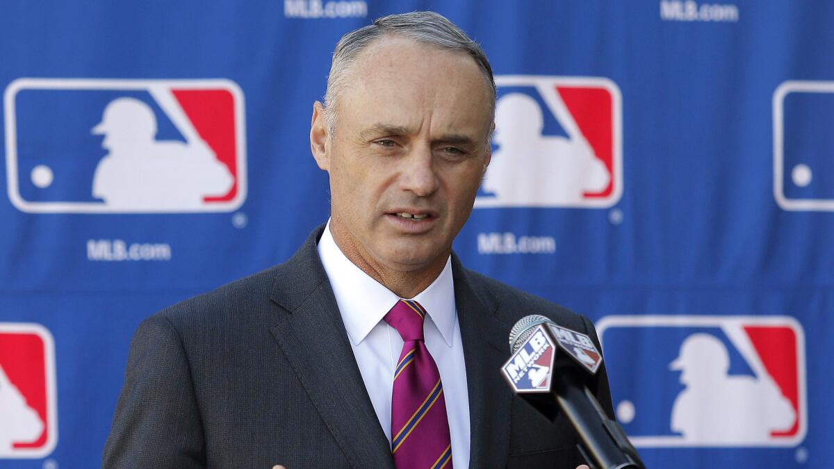 Major League Baseball Commissioner Rob Manfred speaks during a news conference in Phoenix.