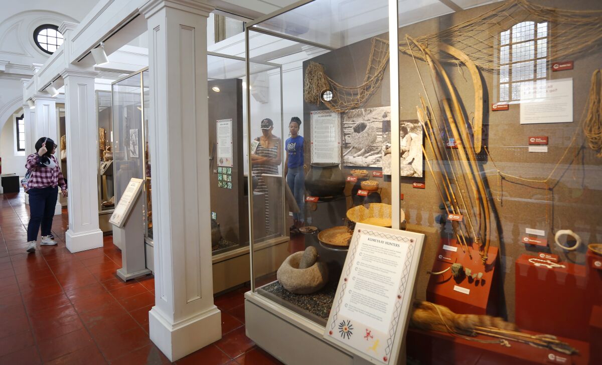 Visitors look at the Kumeyaay exhibit in 2018 at the Museum of Man, now the Museum of Us, in San Diego.