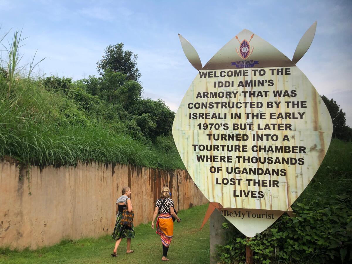 Tourists walk into a bunker in Kampala where leader Idi Amin sent political opponents to die.