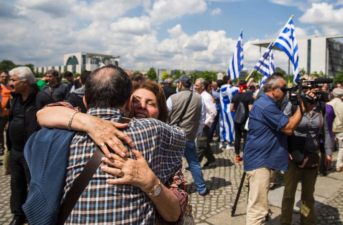 Activists embrace outside the Bundestag in Berlin after lawmakers voted to recognize the Armenian genocide on June 2, 2016.