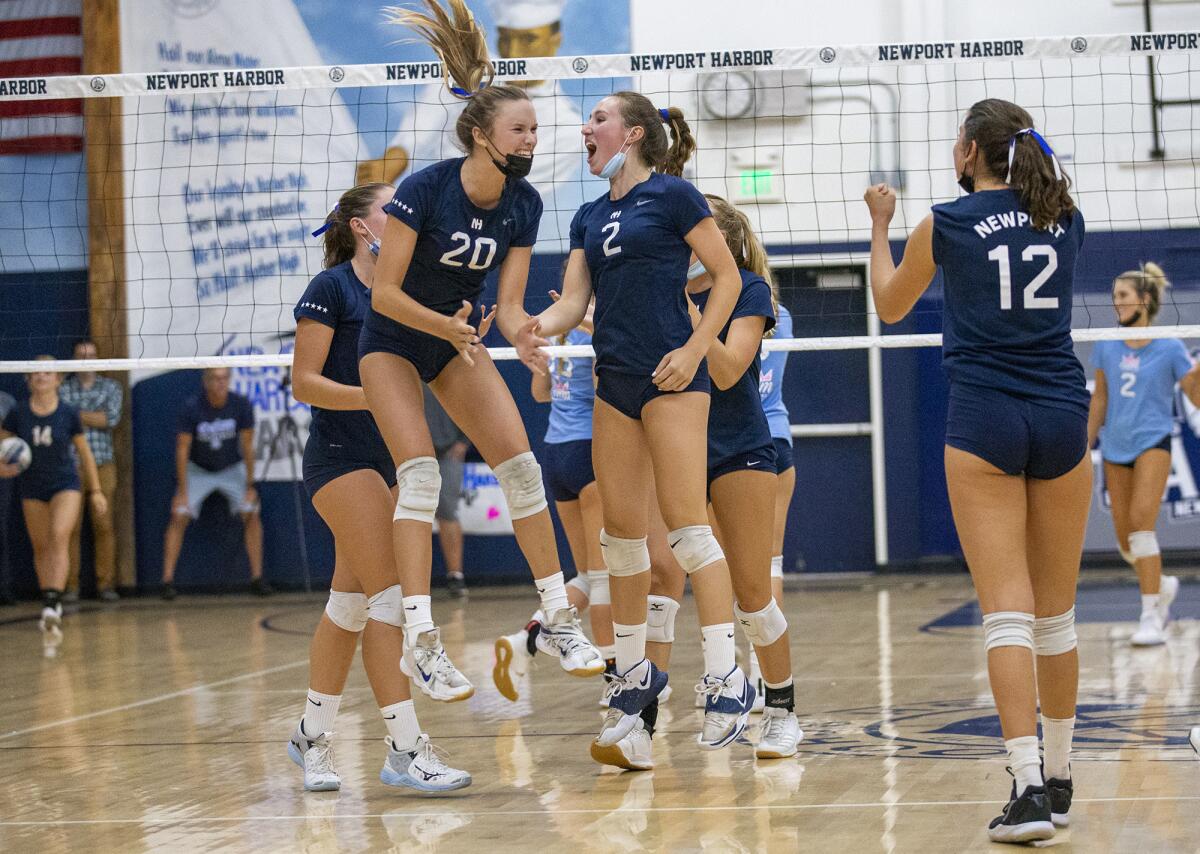 Newport Harbor's girls' volleyball team celebrates after sweeping Corona del Mar 3-0 during the Battle of the Bay.