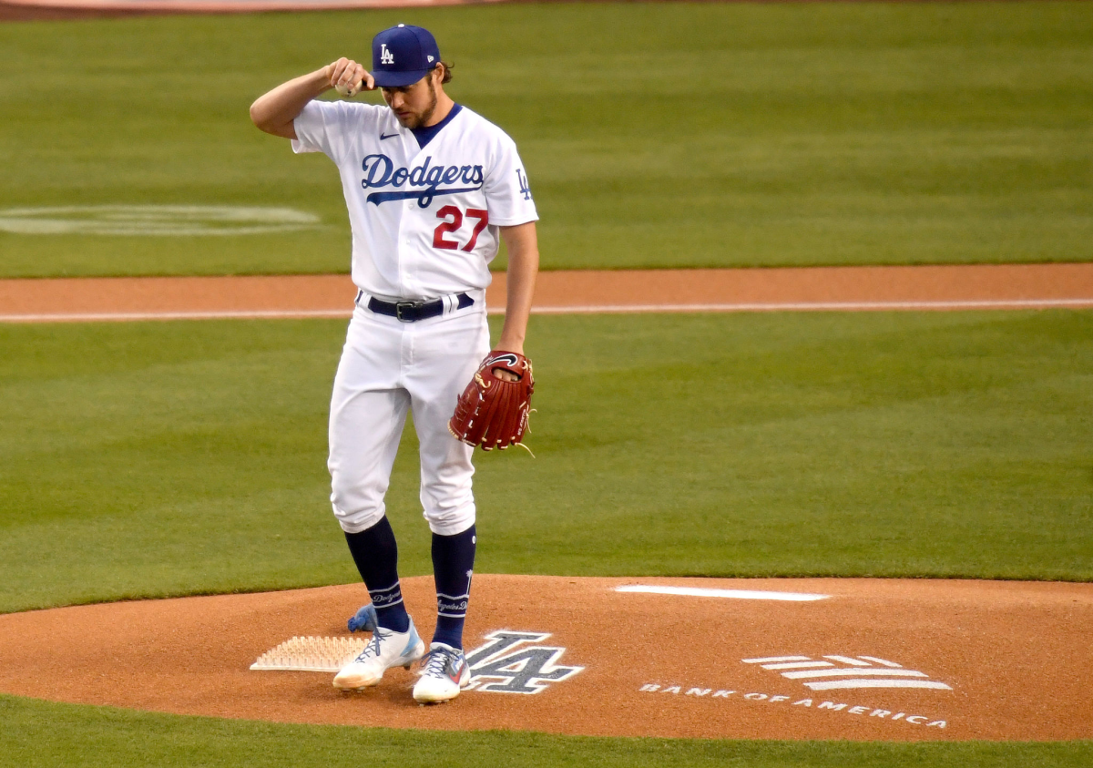 Dodgers pitcher Trevor Bauer adjusts his cap while standing on the mound before a game