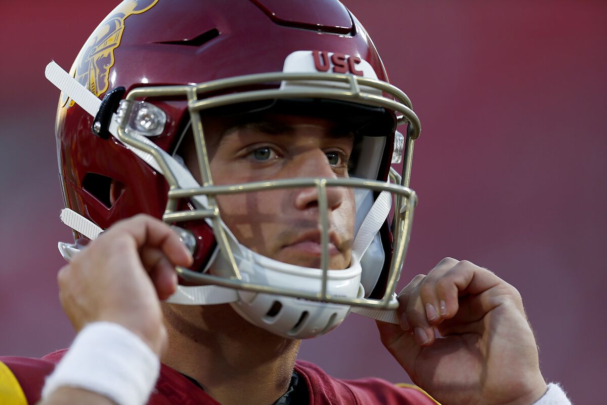 USC quarterback Kedon Slovis straps on his helmet before a game against Stanford on Sept. 7 at the Coliseum.