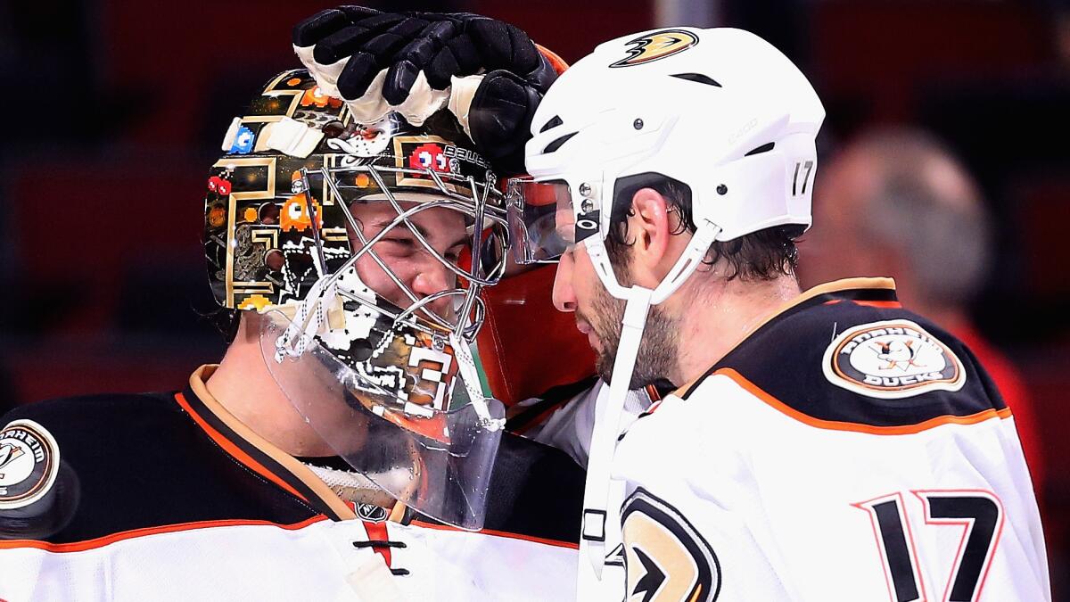 Ducks goalie John Gibson, left, is congratulated by teammate Ryan Kesler after a 1-0 win over the Chicago Blackhawks on Tuesday.