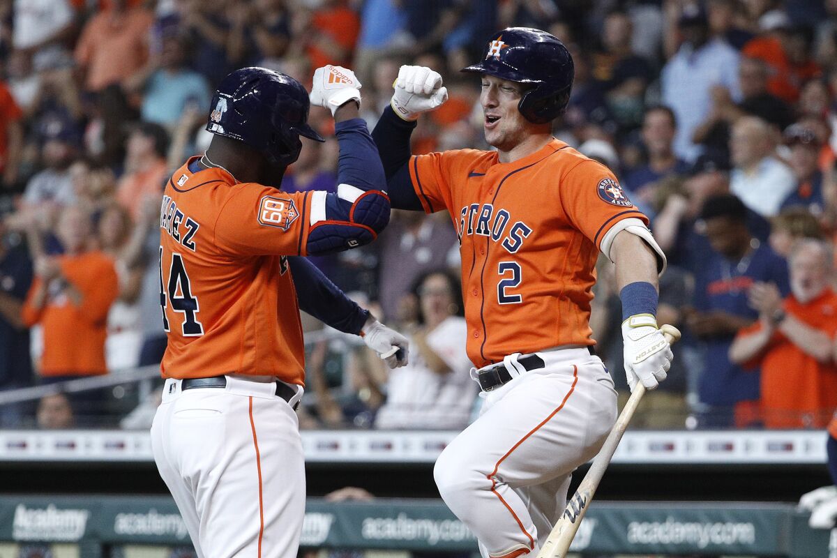 Houston Astros' Yordan Alverez, left, celebrates with Alex Bregman after hitting a solo home run off New York Yankees starting pitcher Domingo German during the first inning in the second game of a baseball doubleheader Thursday, July 21, 2022, in Houston. (AP Photo/Kevin M. Cox)