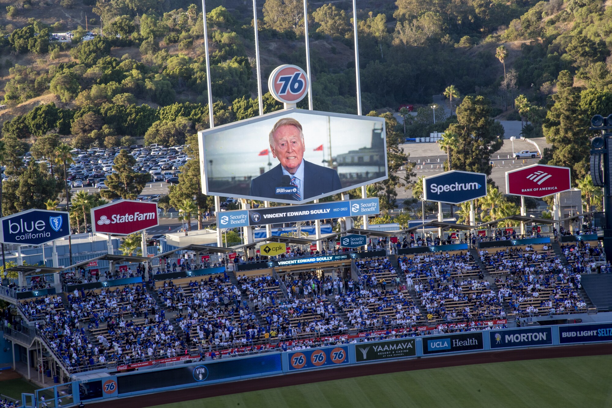 The late Dodger announcer Vin Scully appears on the giant video screen during a tribute to him before the game 