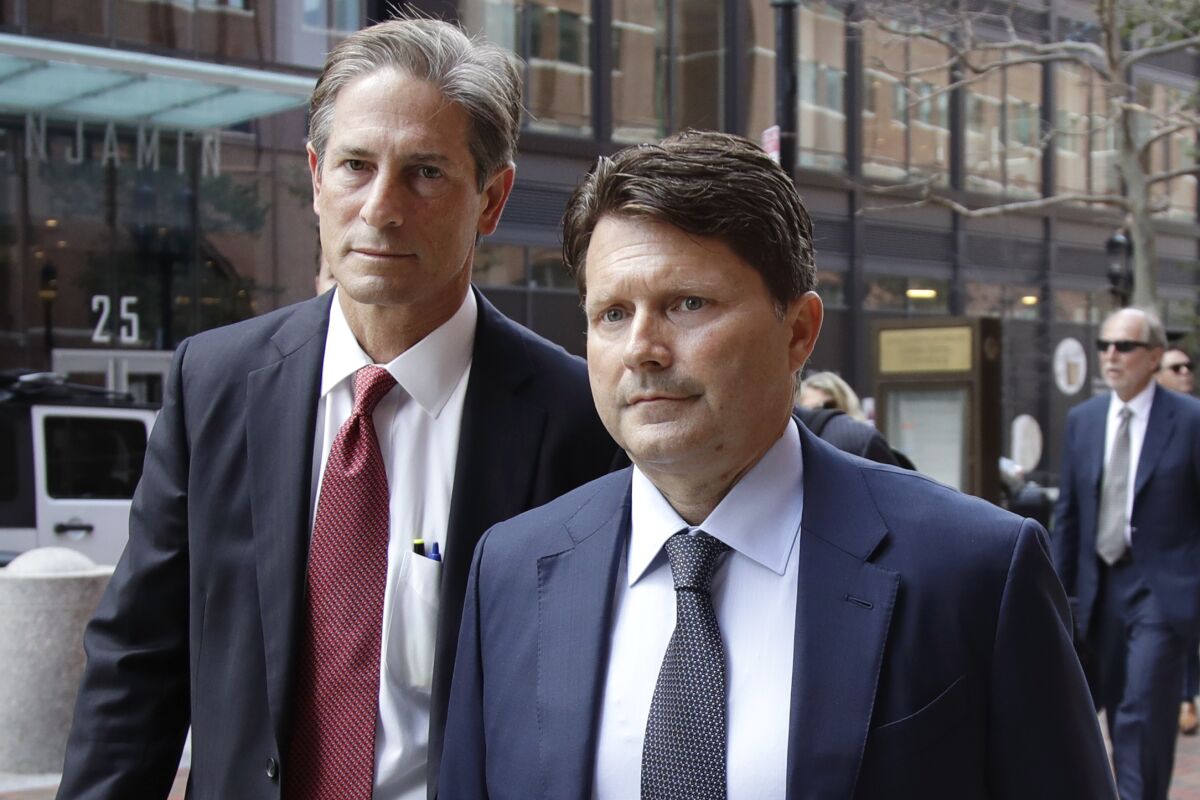 Devin Sloane, right, arrives at federal court in Boston for sentencing in a nationwide college admissions bribery scandal.