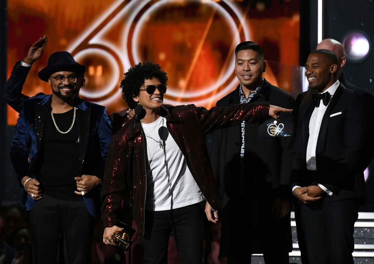 Bruno Mars receives the Grammy for song of the year during the awards ceremony Sunday.