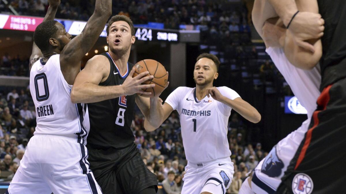 Clippers forward Danilo Gallinari (8) drives between Memphis Grizzlies forwards JaMychal Green (0) and Kyle Anderson (1) in the first half.