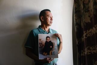 Los Angeles, CA - November 20: Asael Roblero holds a photograph of his son, made years before his schizophrenic diagnosis on Monday, Nov. 20, 2023 in Los Angeles, CA. Roblero has been advocating for his son to get out of Twin Towers and into care more suitable for someone with his mental needs. (Dania Maxwell / Los Angeles Times)