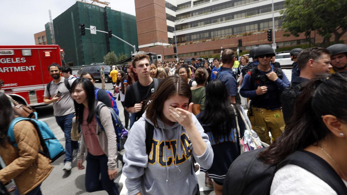 UCLA students evacuate the campus after a shooting Wednesday.