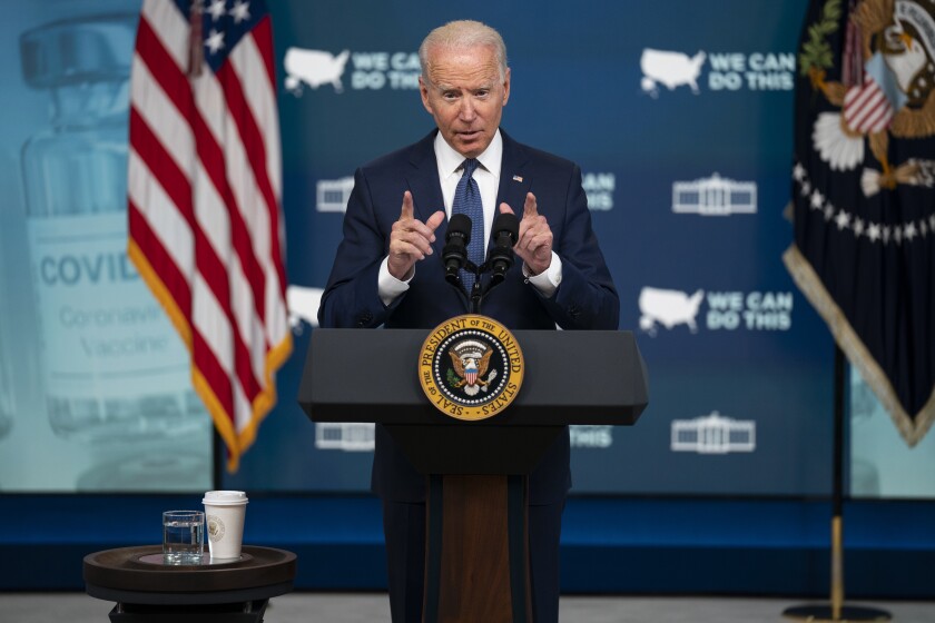 President Biden speaks behind a podium