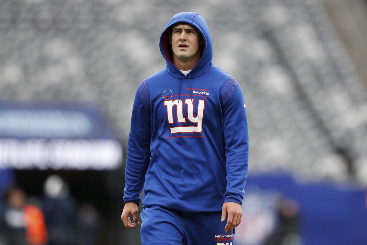 FILE - New York Giants quarterback Daniel Jones (8) works out before an NFL football game against the Dallas Cowboys, on Dec. 19, 2021, in East Rutherford, N.J. Jones has rarely given any insight into his feelings in his three seasons as the New York Giants' starting quarterback. So it was no surprise Thursday, May 19, 2022, when the No. 6 overall pick in the 2019 NFL draft shrugged off how he felt after the Giants refused last month to pick up his fifth year option on his rookie contract. (AP Photo/Steve Luciano, File)
