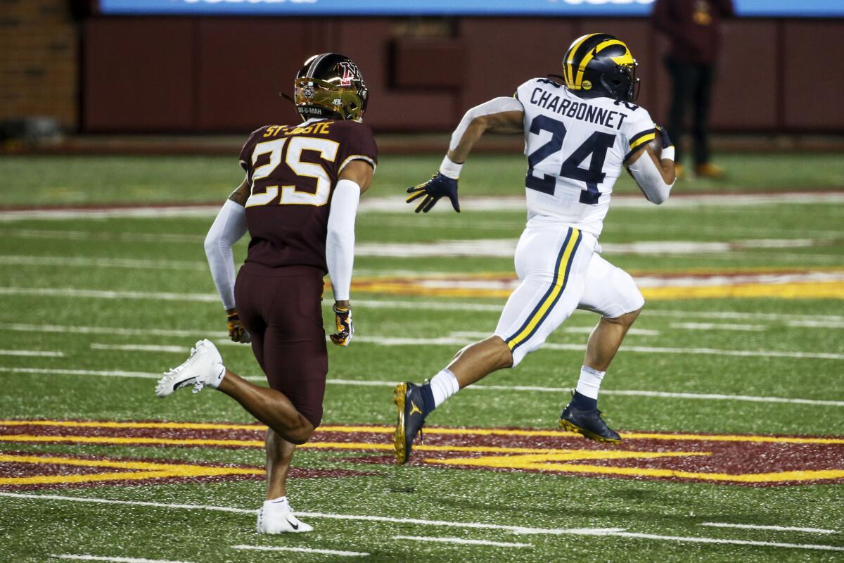 Michigan's Zach Charbonnet breaks away from Minnesota's Benjamin St-Juste for a 70-yard touchdown run on Oct. 24, 2020.