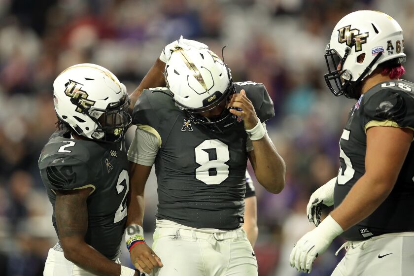 GLENDALE, ARIZONA - JANUARY 01: Running back Otis Anderson #2 hugs teammate quarterback Darriel Mack Jr. #8 of the UCF Knights during the fourth quarter of the PlayStation Fiesta Bowl between LSU and Central Florida at State Farm Stadium on January 01, 2019 in Glendale, Arizona. (Photo by Christian Petersen/Getty Images) User Upload Caption: UFC Otis Anderson ** OUTS - ELSENT, FPG - OUTS * NM, PH, VA if sourced by CT, LA or MoD **