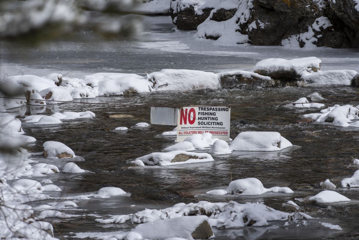 A cable with sign closes off the Pecos River in February south of the Tres Lagunas, N.M.