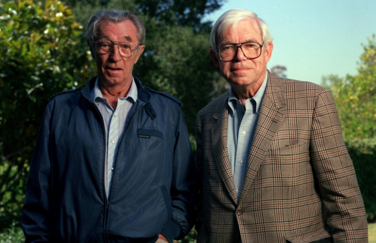 L.A. Times arts editor and film critic Charles Champlin, right, seen here with Robert Mitchum in 1994, influenced many lives.
