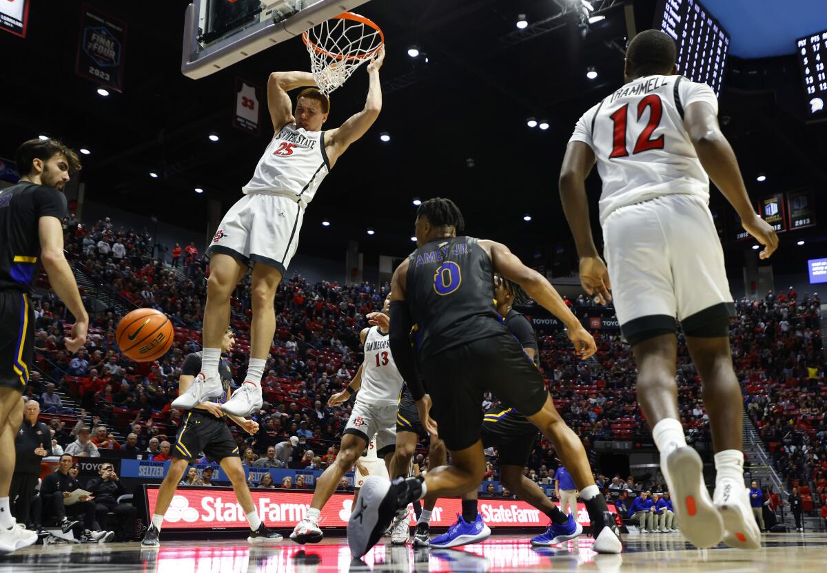 SDSU's Elijah Saunders dunks after an assist from Darrion Trammell on a broken play in the final minute.