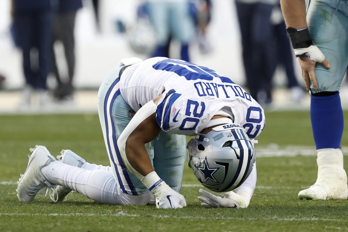 The Cowboys' Tony Pollard (20) injured his ankle in the second quarter and did not return.