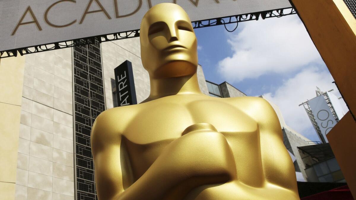 An Oscar statue appears outside the Dolby Theatre for the 87th Academy Awards in Los Angeles. The Oscars are adding a new category to honor popular films and promising a brisk three-hour ceremony on a much earlier air date of Feb. 9, 2020.