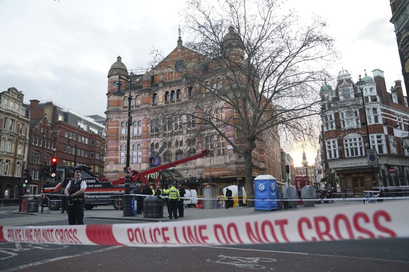 A police tent is erected at Cambridge Circus on the junction between Shaftesbury Avenue and Charing Cross Road in London, Friday, Jan. 27, 2023. A man was crushed to death on Friday by a pop-up urinal in London’s theatre district, police said. (Jonathan Brady/PA via AP)