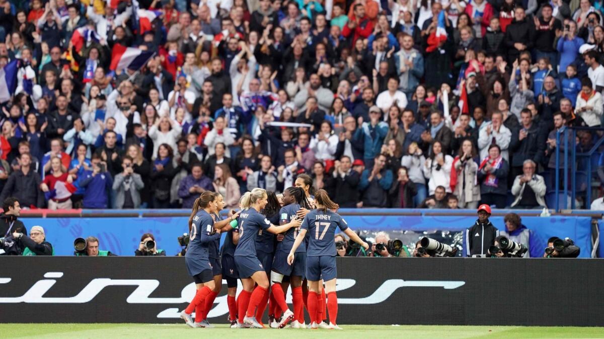 Members of the French national team players celebrate a goal against South Korea in the opening match of the Women's World Cup on June 7 in Paris.