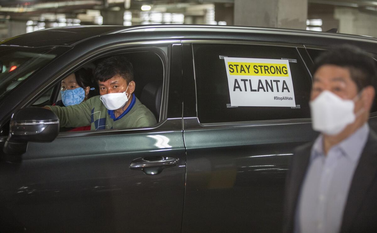A car with a sign on its window that says Stay Strong Atlanta