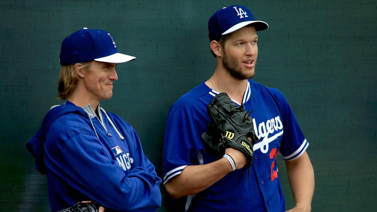 Dodgers starters Zack Greinke, left, and Clayton Kershaw chat during a March 2 workout at spring training.