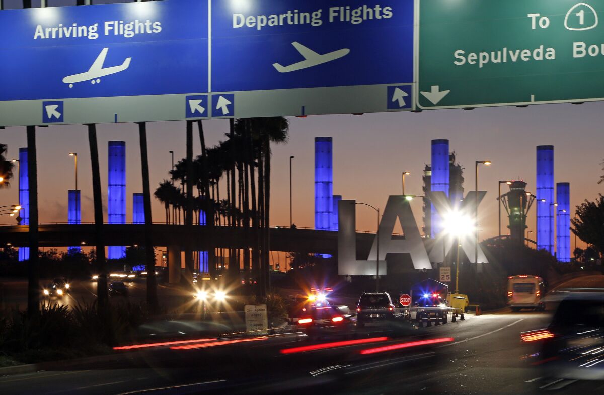 Lighted pylons add color to the Century Boulevard entrance to Los Angeles International Airport.