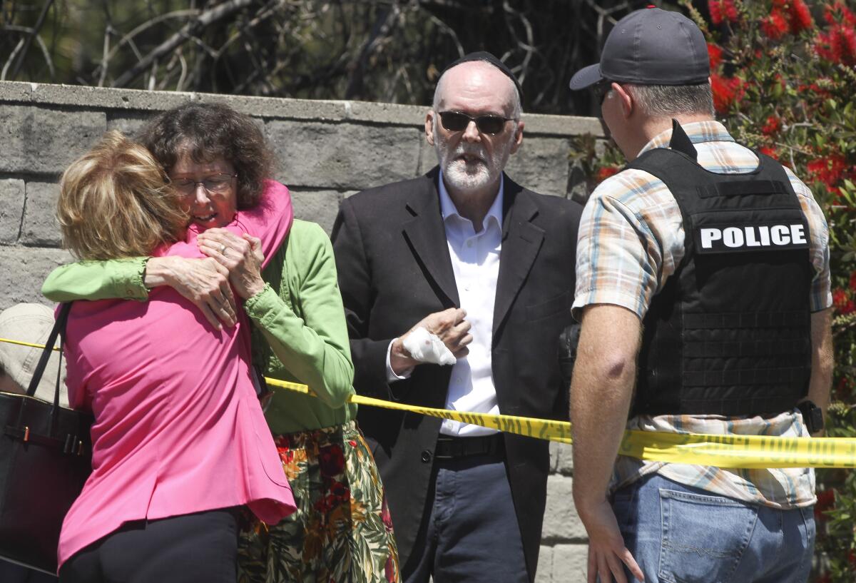 Chabad of Poway members hug after a 19-year-old gunman shot multiple people inside the synagogue.